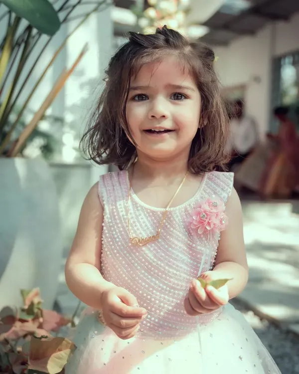 An adorable close-up portrait of a young flower girl at a wedding. We take the time to capture beautiful, natural photos of the children and special guests at your event.