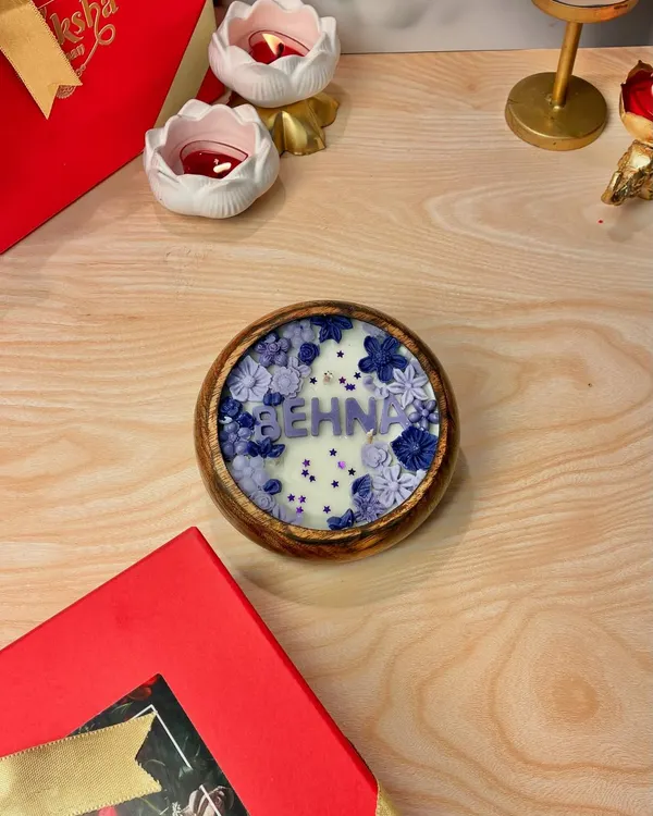 This Rakhi, let your love glow. This is my "Behna" candle, part of the Bhai, Bhabhi, and Behna collection, designed with beautiful purple flowers in a wooden bowl.