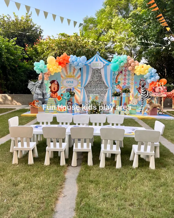 A picture-perfect kids' dining area set against a colorful circus-themed backdrop. Our white tables and chairs provide a clean, comfortable space for children to enjoy their meals and feel like VIPs at the party.
