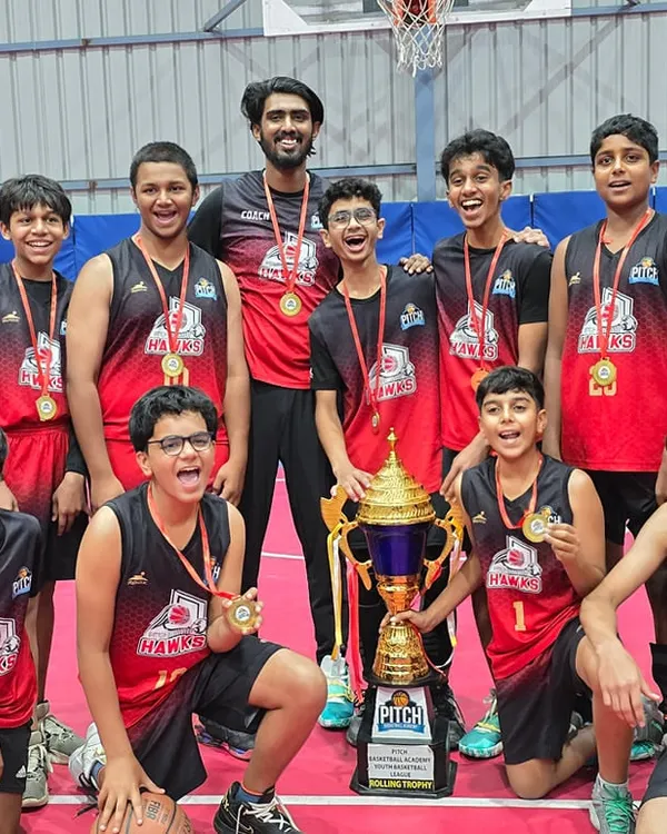 Champions. The Pitch Hawks team proudly holding the Basketball Youth League Season 2 trophy after a season of hard work and dedication.