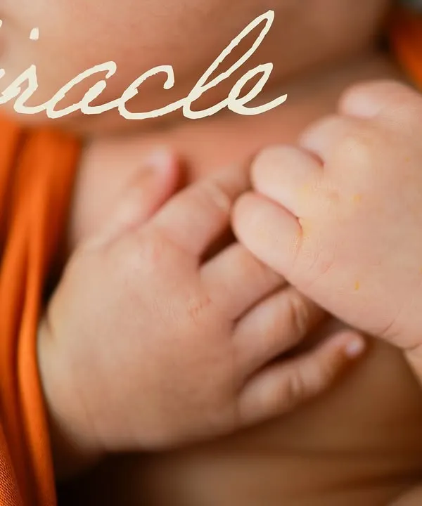 A miracle in the making. This close-up on the baby's tiny, clasped hands shows just how delicate and perfect they are. It's a simple, powerful image.
