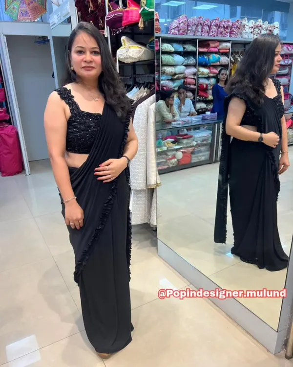 A full look at the stunning black ready-to-wear ruffled saree. The sequined blouse adds the perfect amount of sparkle, while the pre-draped style ensures a flawless silhouette.