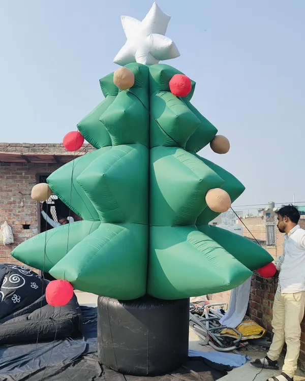 A large inflatable Christmas tree, complete with a star on top and baubles. This was being set up on a rooftop for a client's Christmas display.