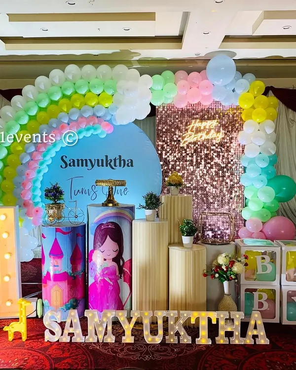 A beautiful rainbow theme with a princess twist. The pastel balloon rainbow, sequin backdrop, and marquee letters create a dreamy setting for a first birthday.