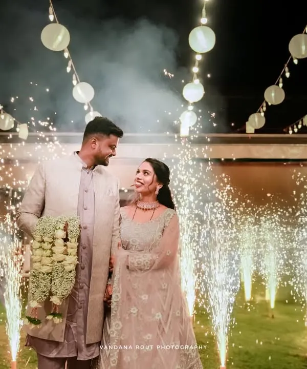 A stunning wide shot of a couple making their reception entrance, surrounded by sparklers and beautiful string lights. I specialize in capturing these dramatic, fairytale moments for your engagement or reception photography.
