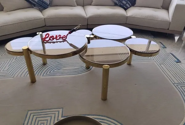 Devised to stand out, our distinctive Aarhus coffee table is not for run-of-the-mill interiors. The design features a cluster of five glass tops at varying heights, all supported by a polished gold metal frame.