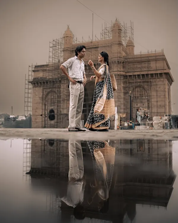 A reflection of love at the Gateway of India. This shot is the essence of my '90s Bombay' series, blending iconic architecture with a quiet, romantic moment to create a powerful, cinematic couple portrait.