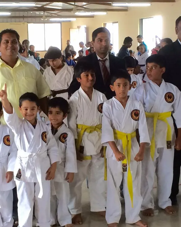 Posing with my youngest students and fellow officials. Guiding the next generation is a responsibility I hold with pride.