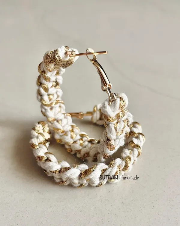 These are my macrame hoop earrings, made with white cotton and a shimmery golden thread. They are lightweight and perfect for parties or festive occasions.