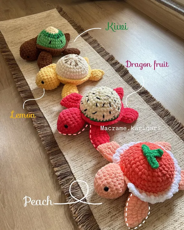 Our full fruit-themed turtle lineup. Here you can see the Kiwi, Lemon, Dragon Fruit, and Peach designs all together. Each shell is uniquely designed to look like a slice of fruit, making them a fun and quirky collectible.