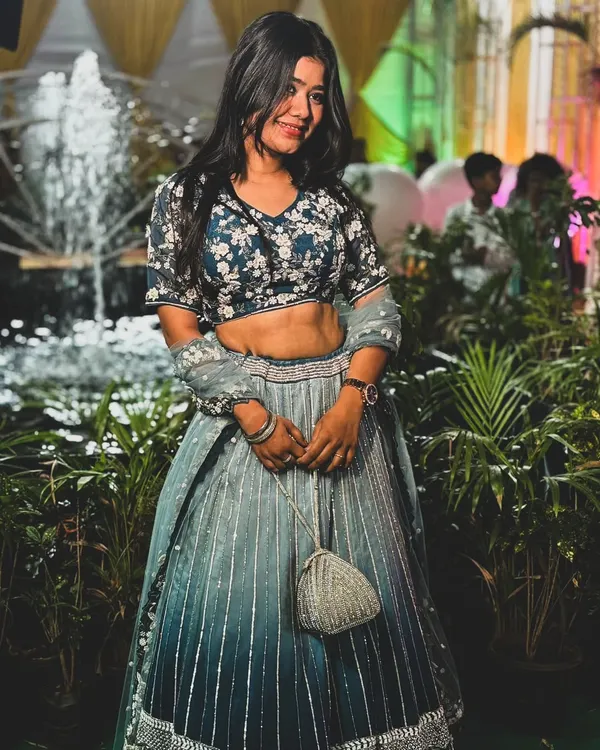 Our client looks stunning in this ombre blue and grey lehenga with a floral embroidered blouse. It's a perfect choice for a sangeet or reception party.