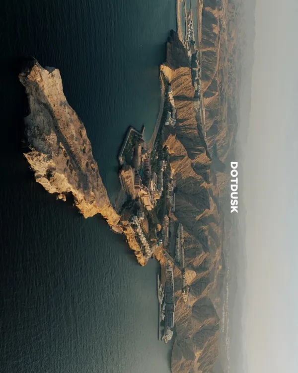 An aerial view of the dramatic cliffs and serene waters of Muscat, Oman. This was the spectacular backdrop for a wedding where modern luxury met timeless tradition.