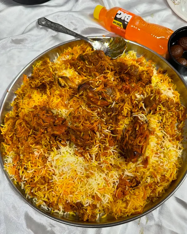 A huge thaal of my Chicken Drumstick Biryani, ready to be served. The rice is fragrant and the drumsticks are cooked perfectly, making it a lazeez meal for any party.