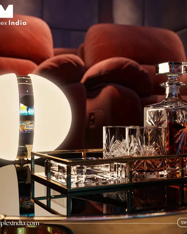 It's the little details that complete the luxury experience. A custom side table with a decanter and glasses, softly lit by an elegant lamp, makes the theater feel like a private, first-class lounge.