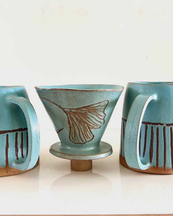 A beautiful, nature-inspired pour-over coffee set with matching mugs, created by a student as a special, handmade gift.