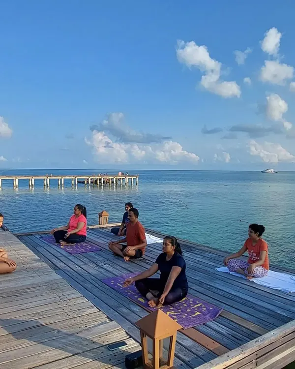 A morning meditation session on our private dock in the Maldives. We begin each day by grounding ourselves, surrounded by the endless blue of the ocean and sky.