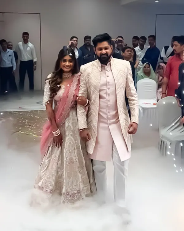 This is a beautiful shot of a couple I styled for their wedding event. The groom's light pink sherwani with geometric texturing perfectly complements the bride's white and pink embroidered lehenga.