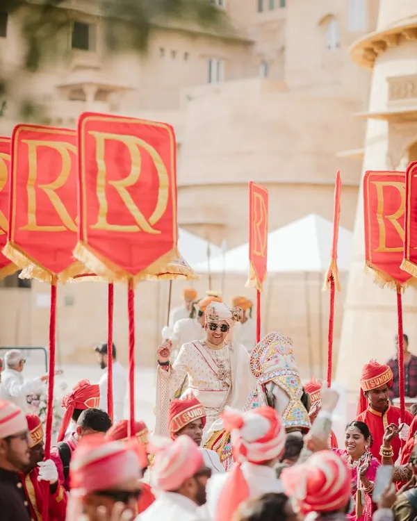 It's the little things that pack the most meaning. For this royal Rajasthani wedding, we created personalized flags with the couple's monogram, adding a regal and bespoke touch to the groom's procession.