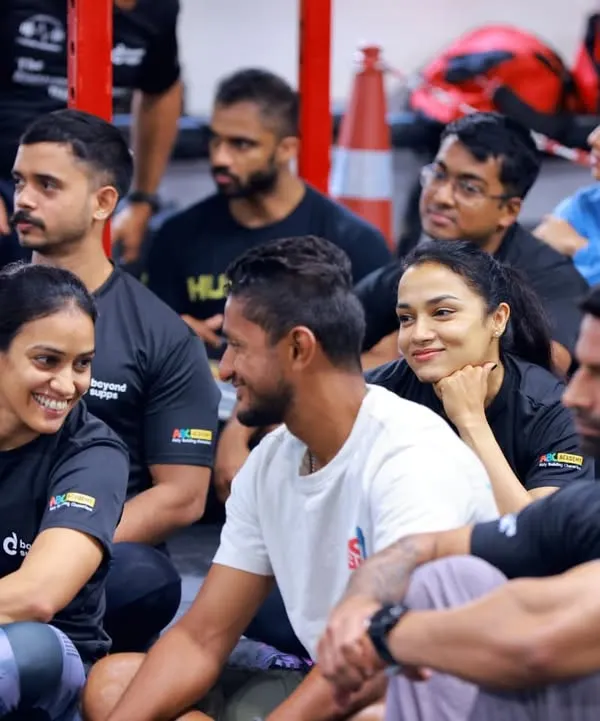 The moments between workouts are just as important. Here, our members listen in during a briefing, sharing smiles and getting ready for the next challenge together.