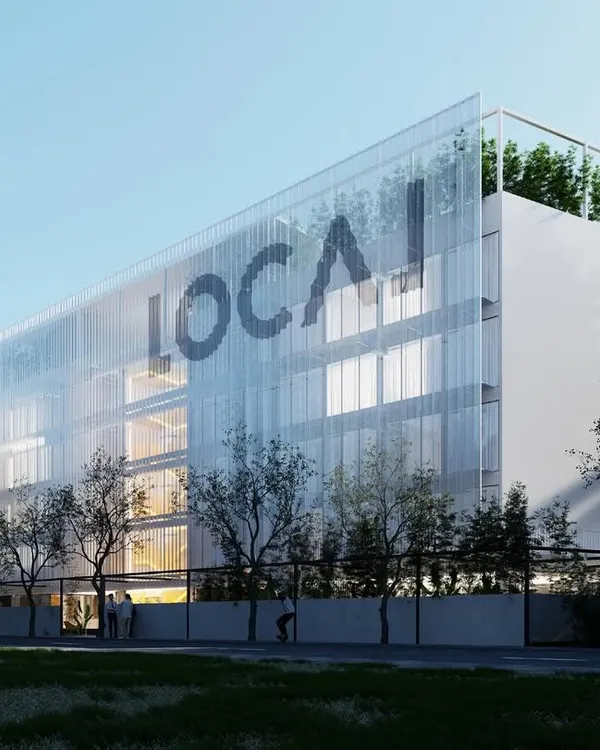 For this co-living project, we used a large, perforated mesh screen to wrap the facade. This allows for ample natural light while obscuring visual clutter like air conditioning units, maintaining a coherent and clean aesthetic.