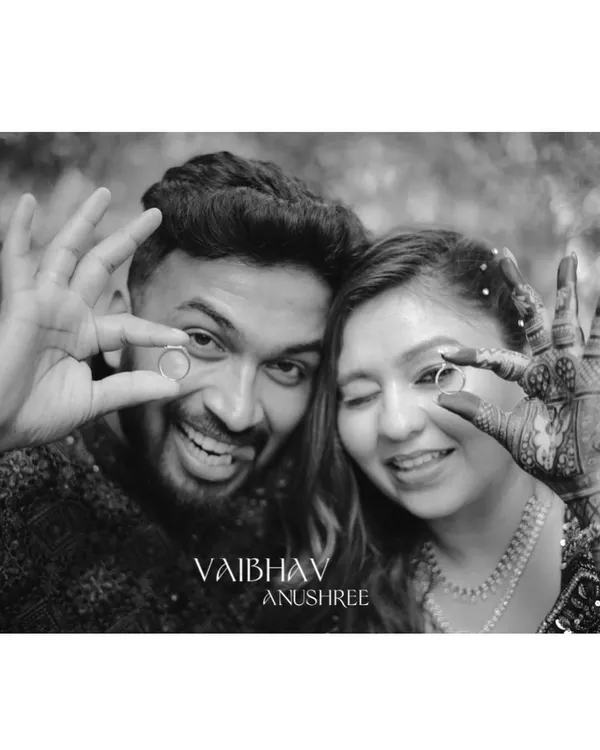 A fun and playful black and white shot of the newly engaged couple showing off their rings. It's a perfect way to announce the new beginning!