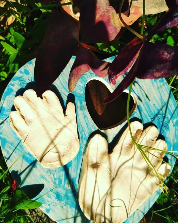 This custom heart-shaped plaque captures a baby's tiny hand and foot imprints, creating a timeless family keepsake. It’s one of my favorite ways to use clay to preserve a precious moment forever.