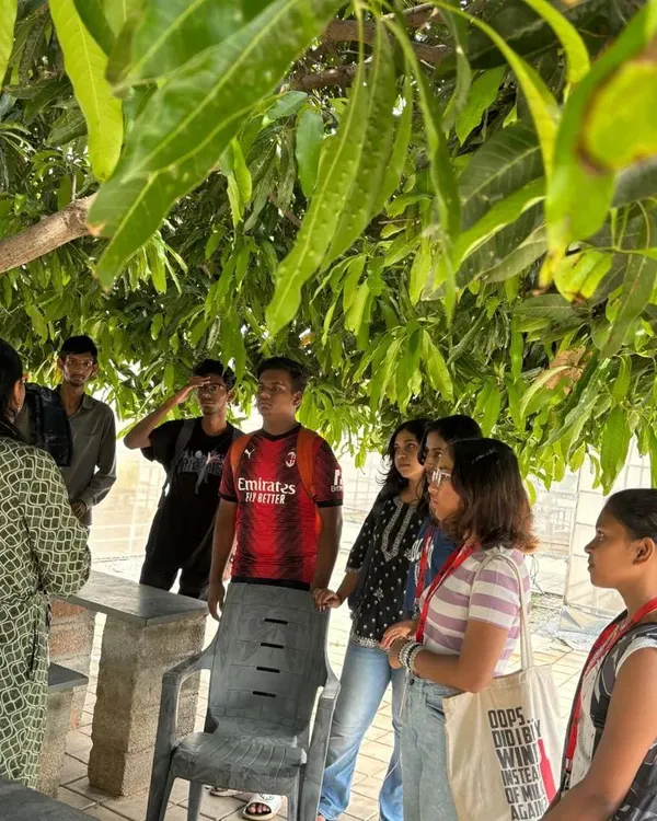 An interactive session with students under the shade of a mango tree. We discuss the principles of farming and hydroponics before heading into the greenhouse for practical experience.