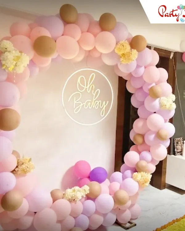 An elegant "Oh Baby" themed setup perfect for a sophisticated baby shower. I used a pastel palette of pink, lilac, and beige balloons to create this soft circular arch, adding a custom neon sign as a lovely focal point.