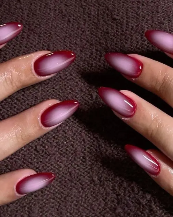 A dramatic and moody red and black aura nail. The gradient effect is perfect for a bold, vampy look.