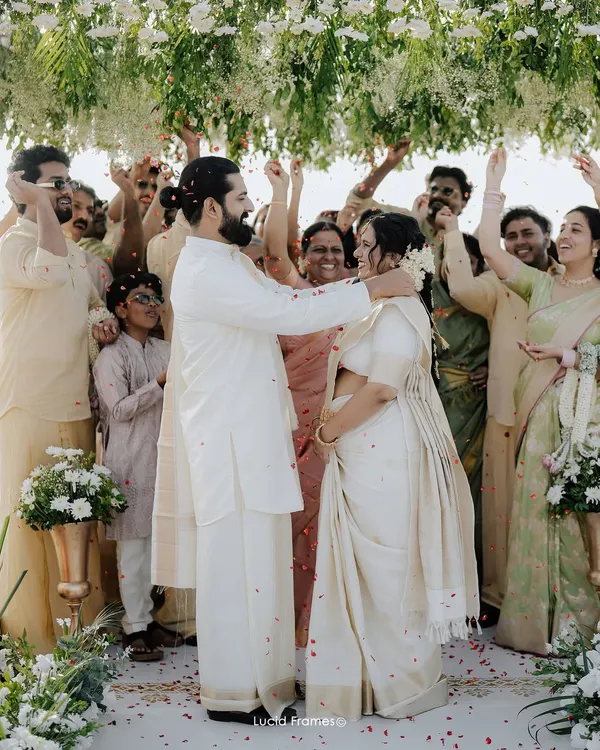 Surrounded by the love and blessings of family, the couple shares a moment of pure joy during their Kerala wedding ceremony.