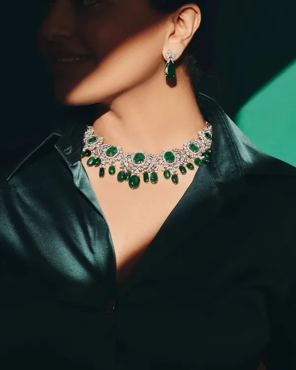 Your daily dose of greens, but make it emerald. A stunning emerald and diamond necklace paired with a deep green silk shirt for a powerful, monochromatic look.