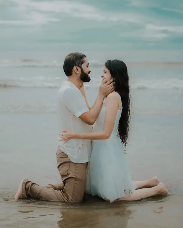 A tender moment on the sand, with the ocean as a witness. This intimate beach pre-wedding photo captures the deep affection between Pragati and Swapnil.