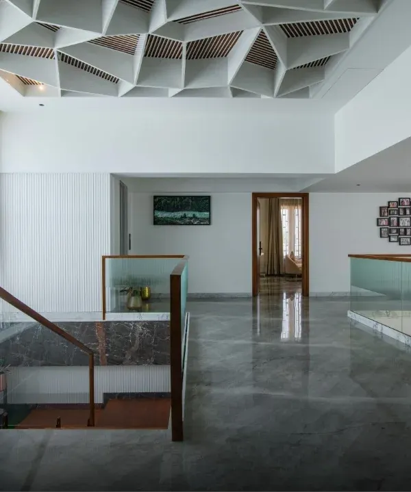 Where geometry meets elegance. This space features an intricate, geometric false ceiling that serves as a statement of art, depth, and craftsmanship.