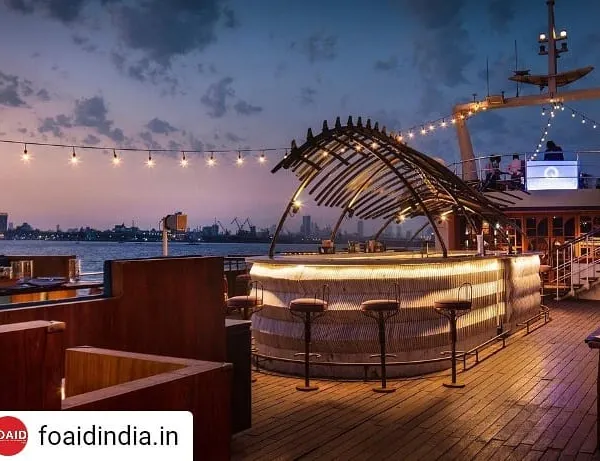 The open-air bar on the upper deck of the Queensline Sea Yah, designed to offer panoramic views of the Mumbai skyline. The skeletal structure above the bar is a custom sculpture inspired by a blue whale skeleton, anchoring the space with a distinct maritime identity.