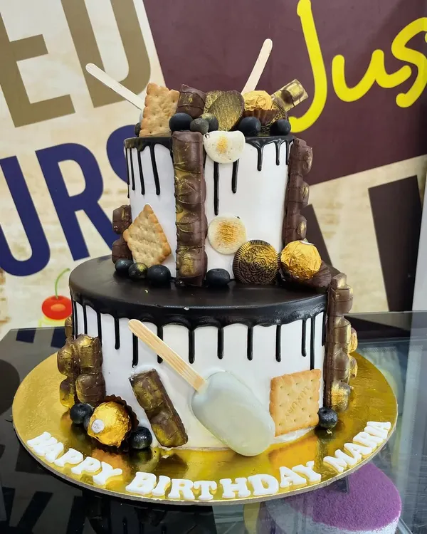A 4kg two-tiered chocolate lover's dream, loaded with various chocolate bars, Ferrero Rocher, and even a cakesicle.