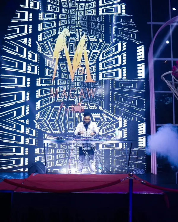 Here I am performing in front of a massive, floor-to-ceiling LED wall with custom geometric visuals. This is the core of my VDJ service, creating a stunning backdrop for any large event.