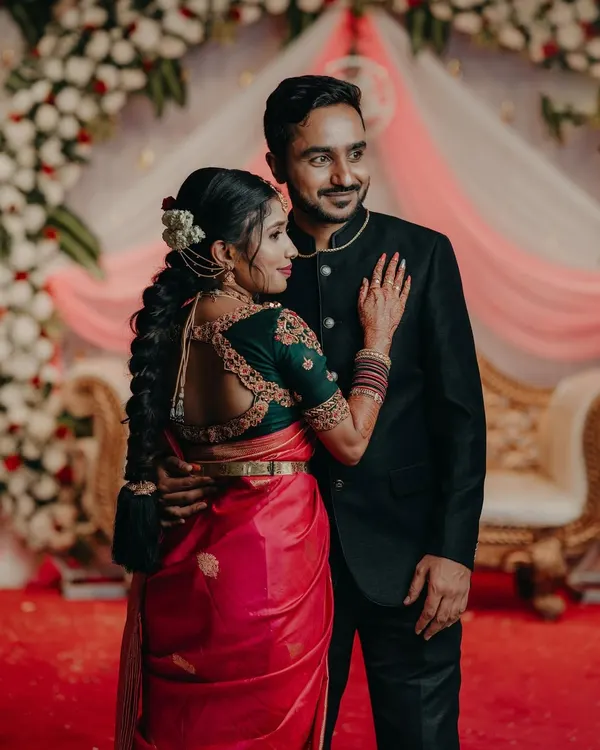 A beautiful couple photo, where the bride's custom green blouse with a detailed back design stands out.