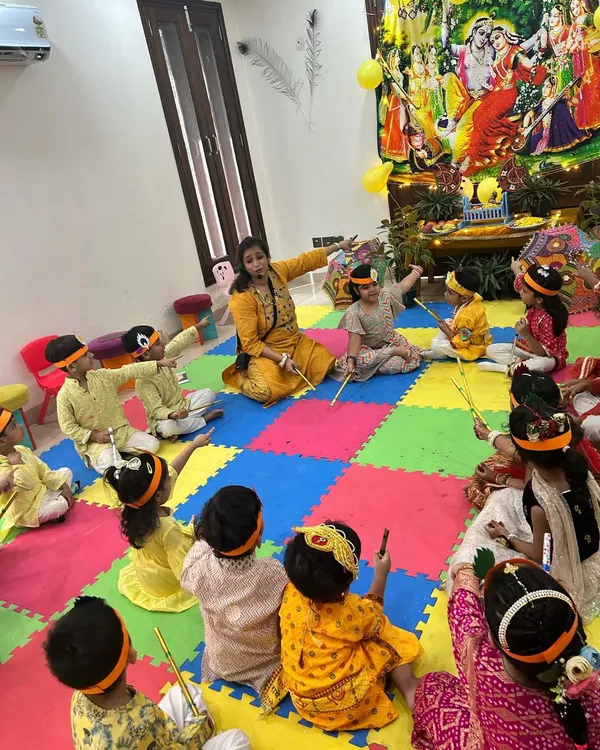 An interactive storytelling session during our Janmashtami celebration. The children, dressed in festive attire, are completely engaged as they learn about the story of Lord Krishna in a vibrant and colorful setting.