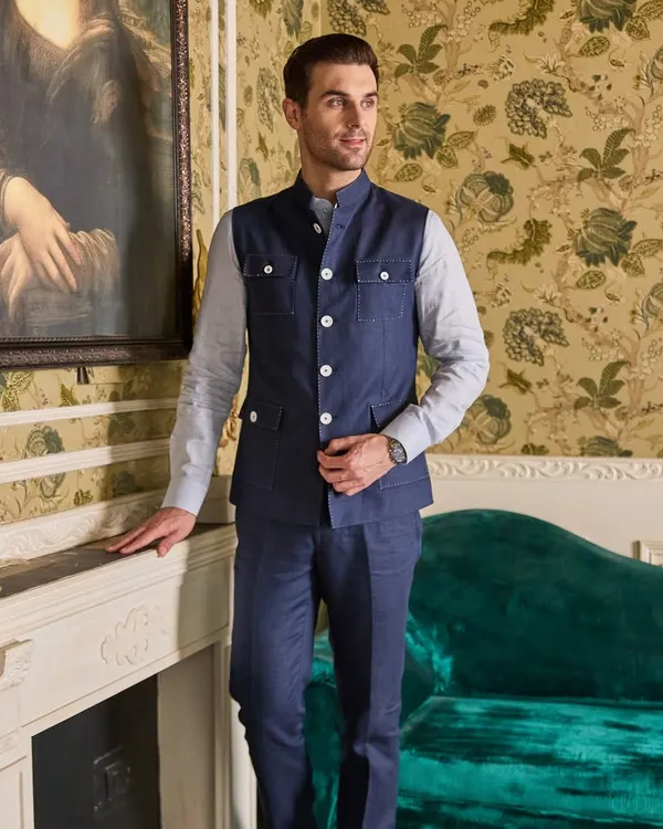 Presenting my Hunter Style Waistcoat in midnight blue. This piece blends rugged charm with timeless sophistication, featuring four pockets and a structured fit. Paired with a comfy linen shirt, it's the perfect attire for a summer evening.