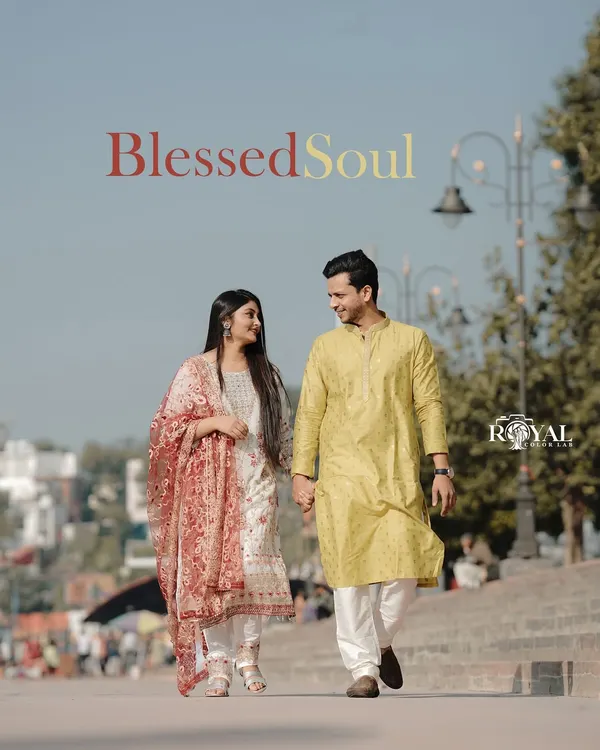A beautiful, candid moment of a couple in traditional attire walking along the Rishikesh ghats, capturing the authentic local vibe.