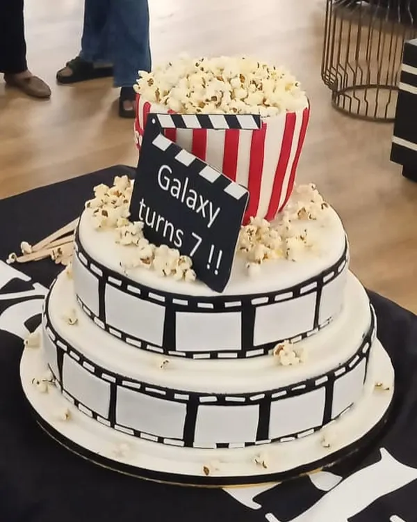 Another angle of the incredible cinema-themed cake for WeWork's anniversary. The details, from the film reel to the popcorn bucket, are all handcrafted and edible.