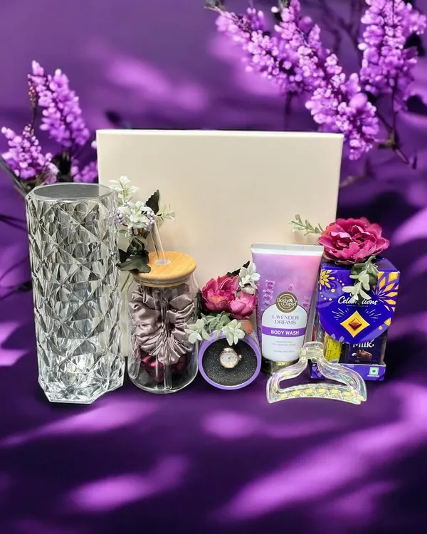 A lovely lavender-themed hamper perfect for a sister or friend. This gift set includes a crystal-cut vase, a jar of scrunchies, lavender body wash, chocolates, and other matching accessories.