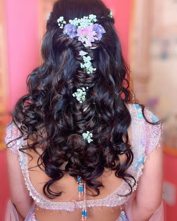 A fairytale hairstyle for a fairytale bride. I created this intricate braided look with soft curls and fresh pastel flowers for an engagement ceremony.