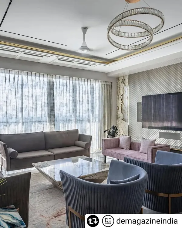 The living room of the 'Fifty Two' apartment in Lower Parel, designed for a well-travelled family. We aimed for a royal look that wasn't over-the-top, using a mix of plush fabrics, a statement chandelier, and a custom Patagonia marble coffee table.