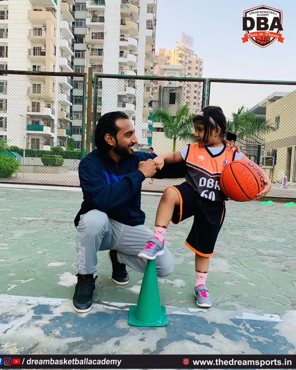 It's more than just coaching; it's about mentorship. Here I am sharing a moment of encouragement with one of our youngest players during a drill.