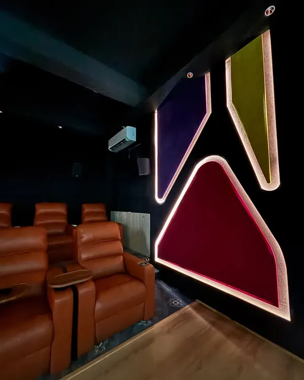This dedicated cinema room features custom acoustic wall panels with integrated lighting, which not only look great but also fine tune the room's sound. The comfortable leather recliners are perfectly positioned for the best viewing and listening experience.