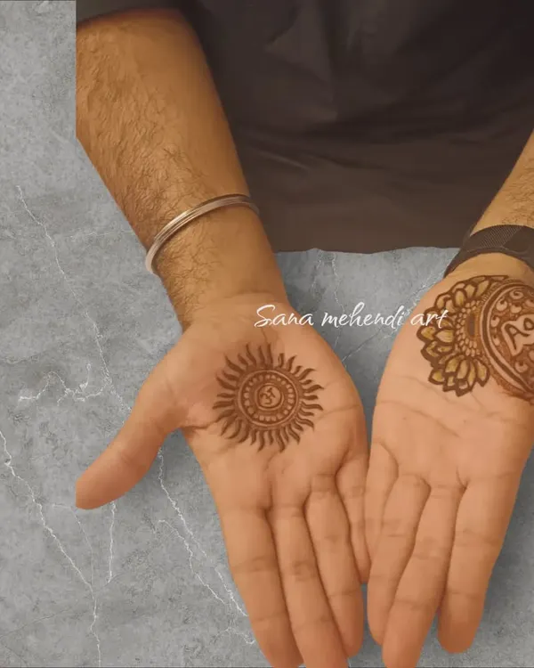 A simple and traditional mehendi for the groom, with a sun motif on one palm and the sacred 'Om' symbol on the other.