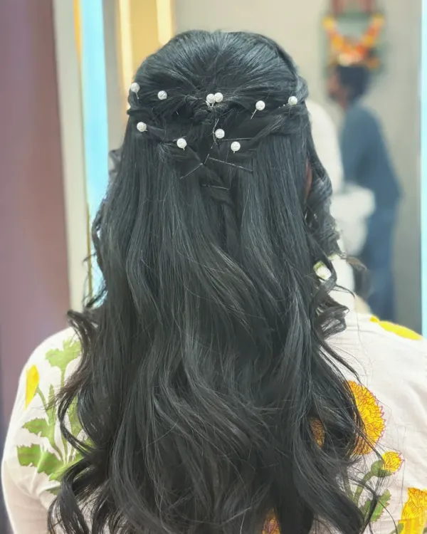 An elegant half-up hairstyle with intricate twists and pearl accessories. This is a perfect look for weddings, parties, or any formal event where you want to look polished.
