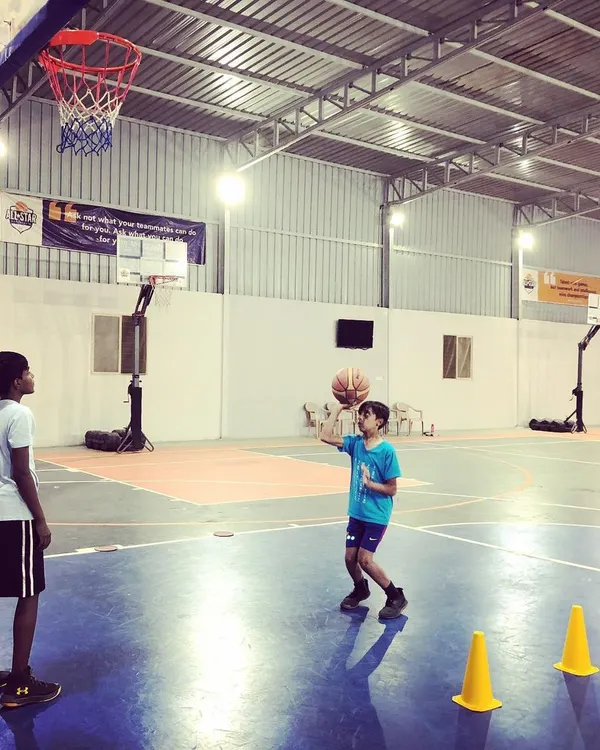 Building a strong foundation is key. Here, a young player works on shooting mechanics with cones for guidance, a common sight during our coaching sessions.
