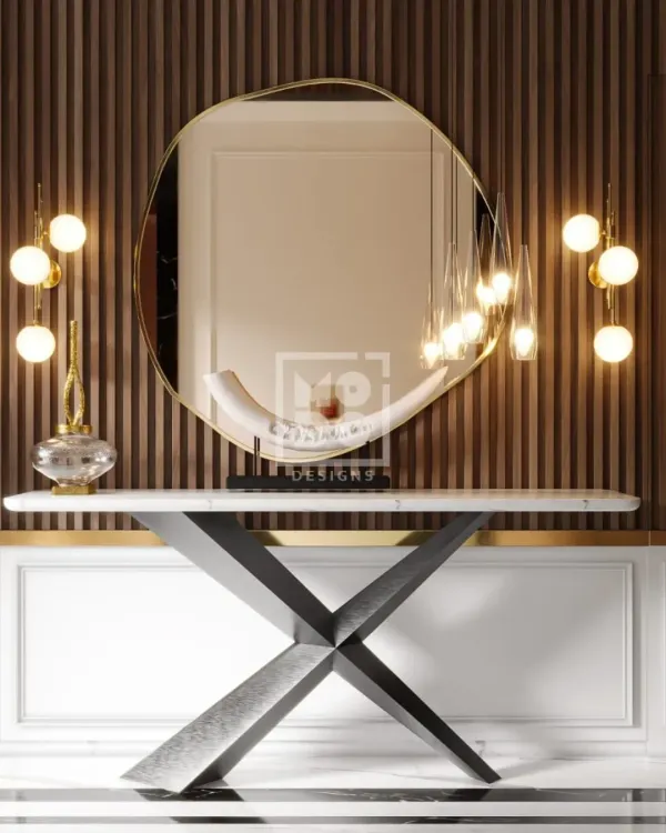 A close-up of the lobby console table, where a modern, abstract mirror and sculptural lighting create an artistic focal point. This composition of clean lines and elegant materials immediately establishes a tone of refined luxury.